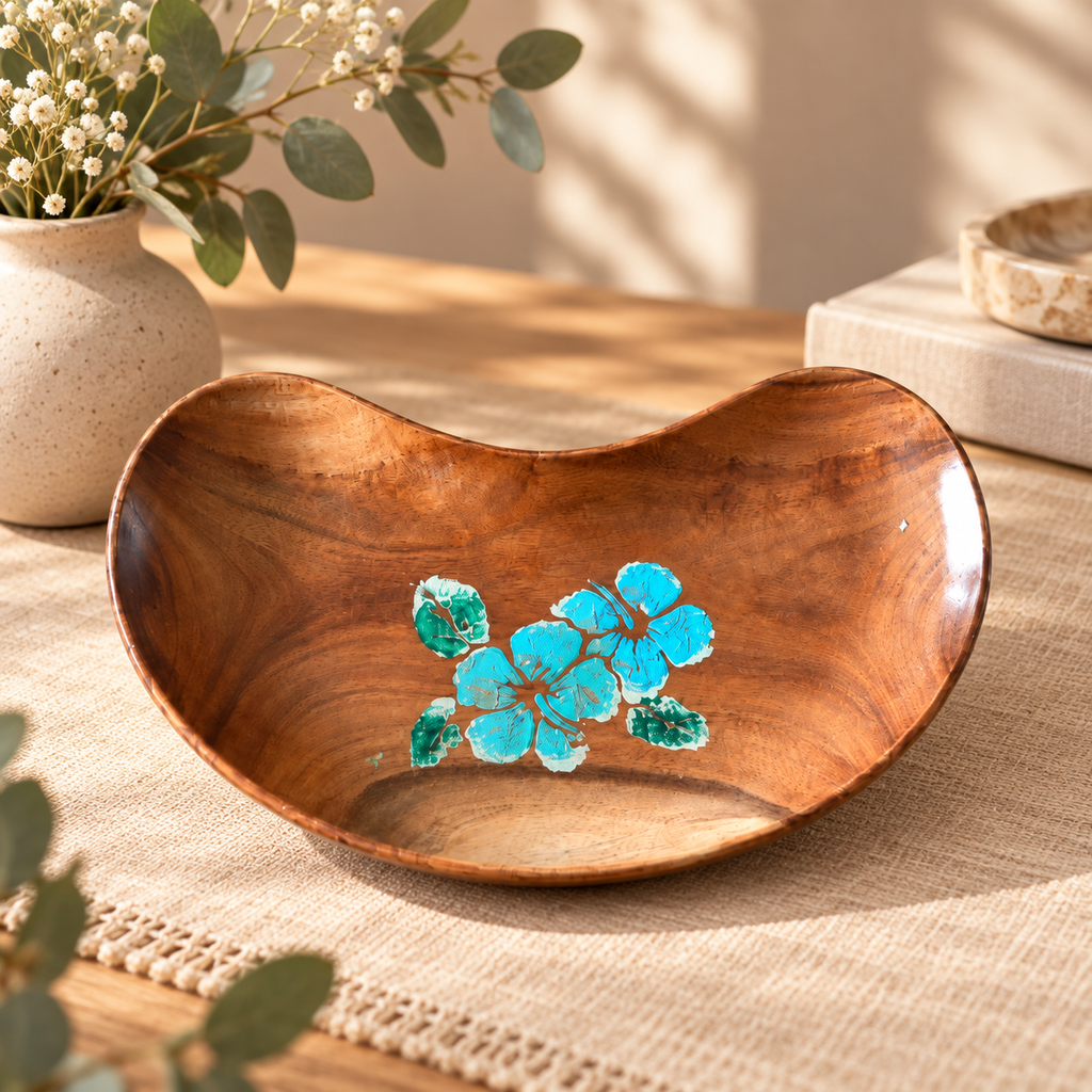 Hand-painted bean-shaped wooden tray with blue floral detail styled on a natural table. hoWme