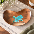 Bean-shaped wooden tray with hand-painted blue flowers on a woven table setting. hoWme