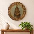 Blue and gold wooden wall plate with brass diya styled above a console – hoWme