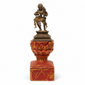 Brass dancing artefact on a red and gold wooden pedestal, tabletop decor. hoWme
