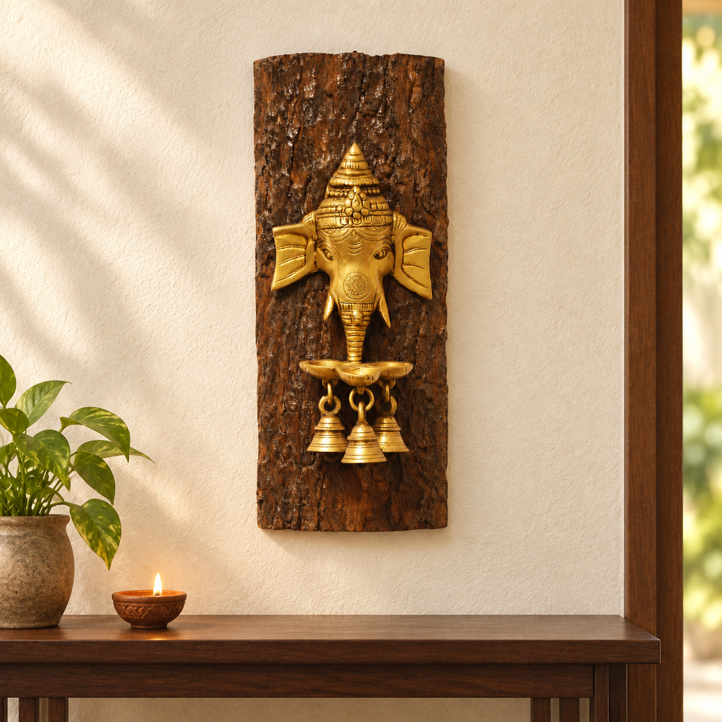 Artisanal brass Ganesha diya on a bark wood log, displayed as wall decor. hoWme