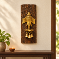 Artisanal brass Ganesha diya on a bark wood log, displayed as wall decor. hoWme