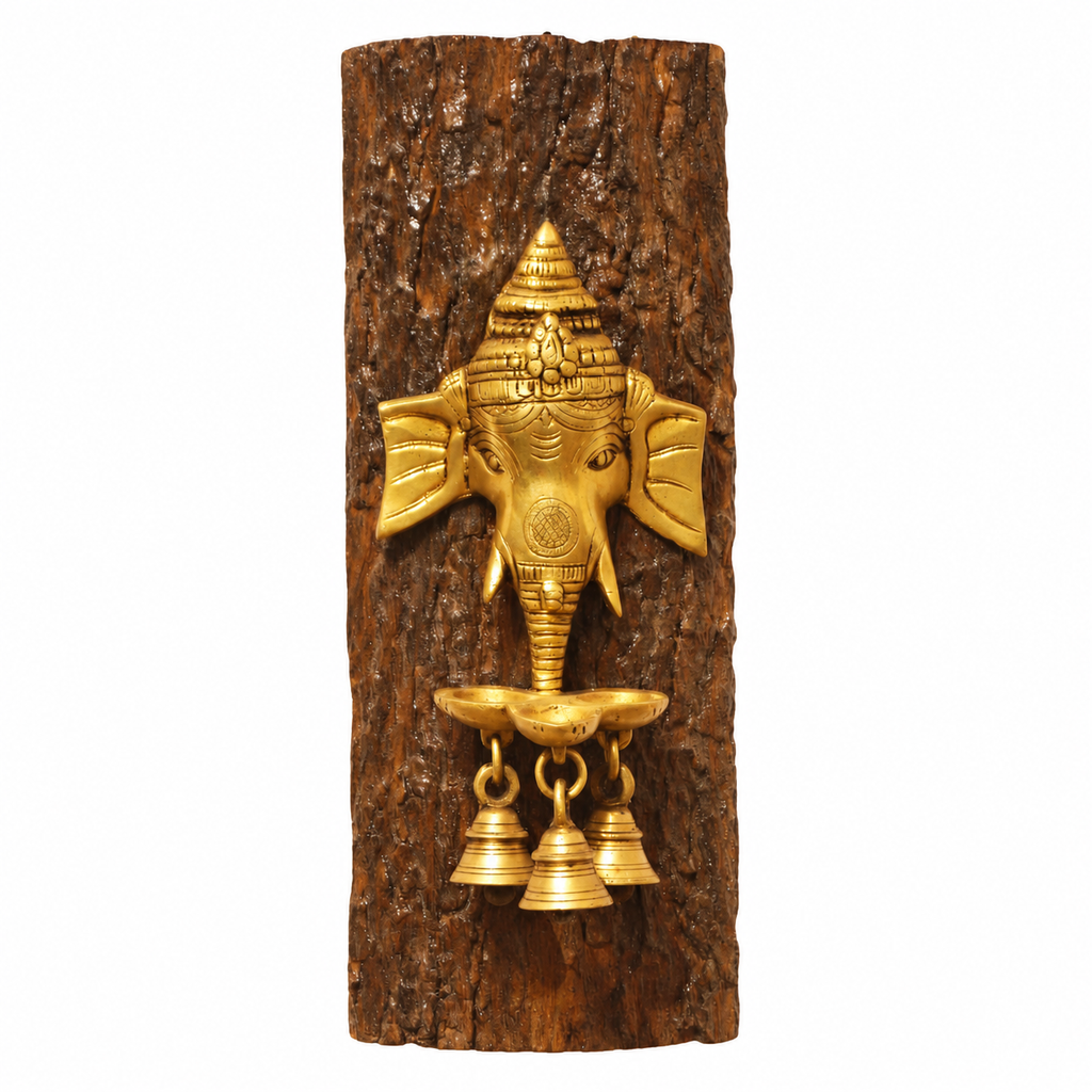 Handcrafted brass Ganesha face with diya on a natural wood log, front view. hoWme