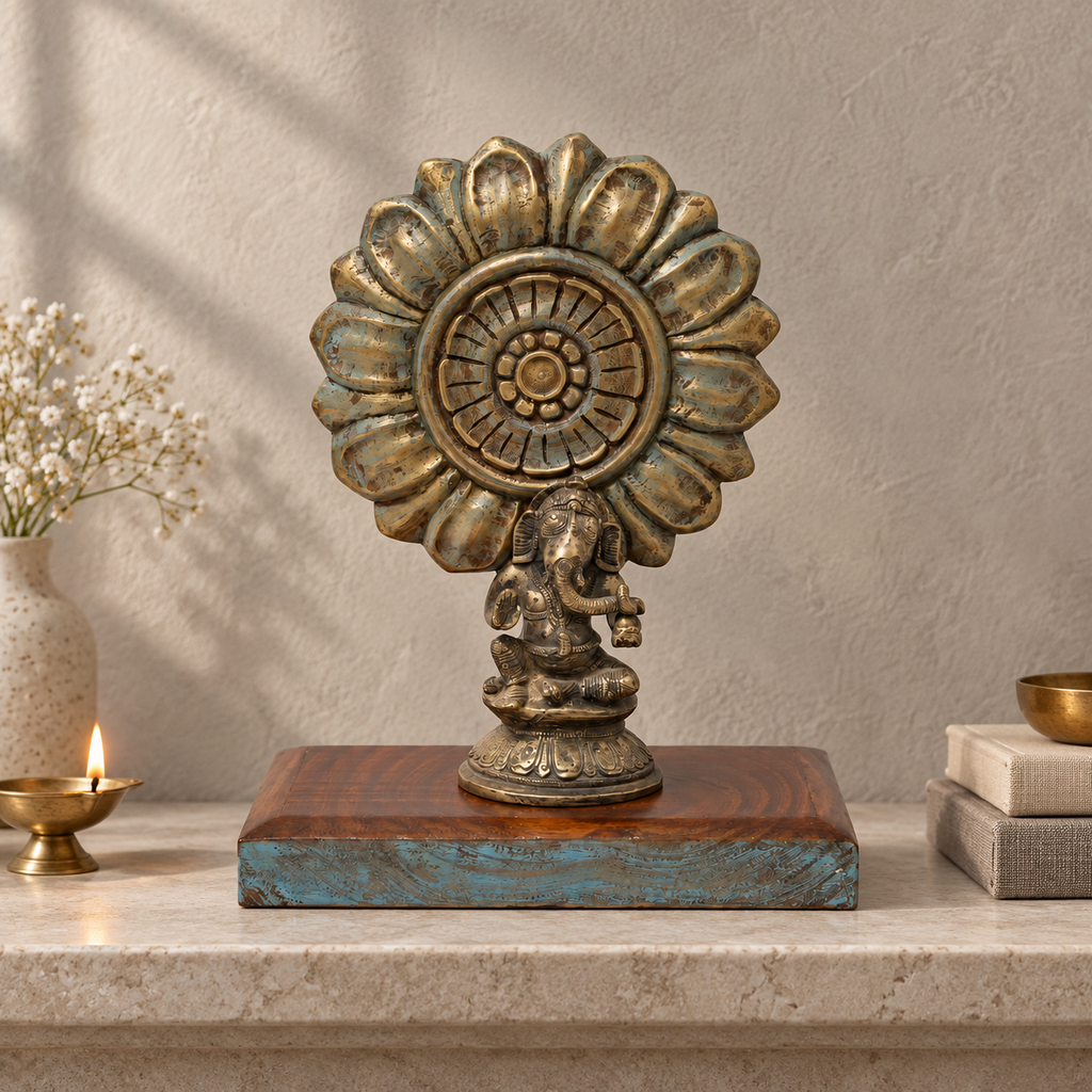 Brass Ganesha tabletop accent with a carved sunburst and wooden base. hoWme
