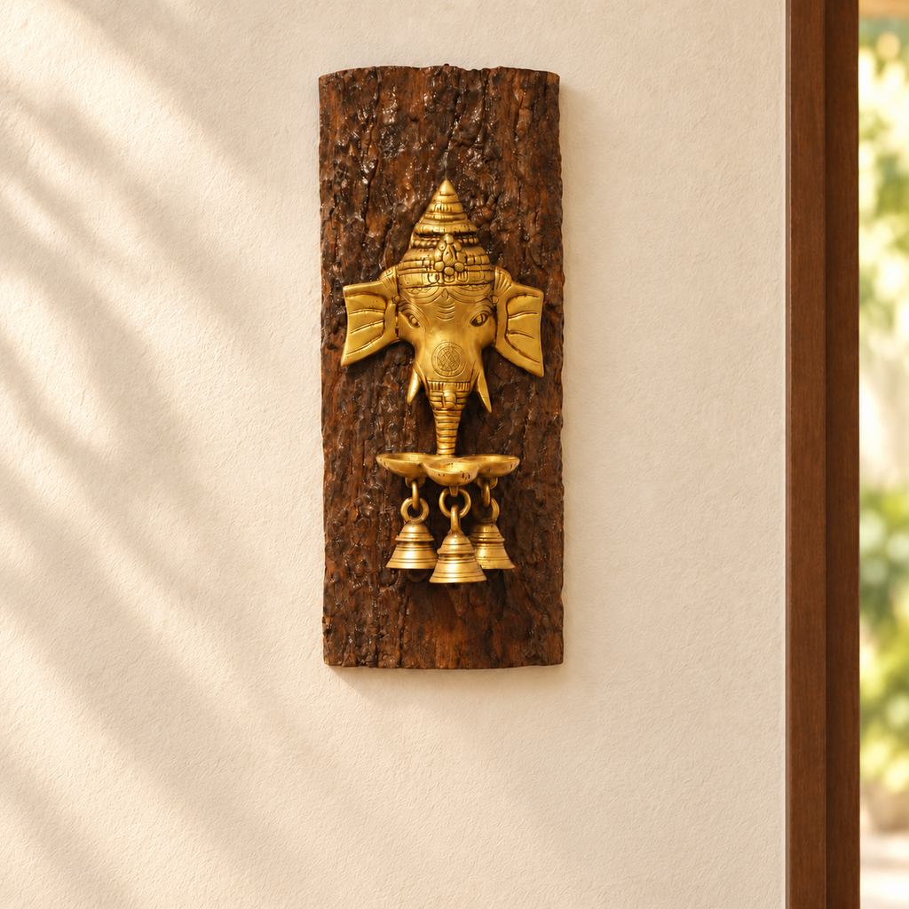 Brown carved wooden wall panel with brass Ganesha face and bells. hoWme