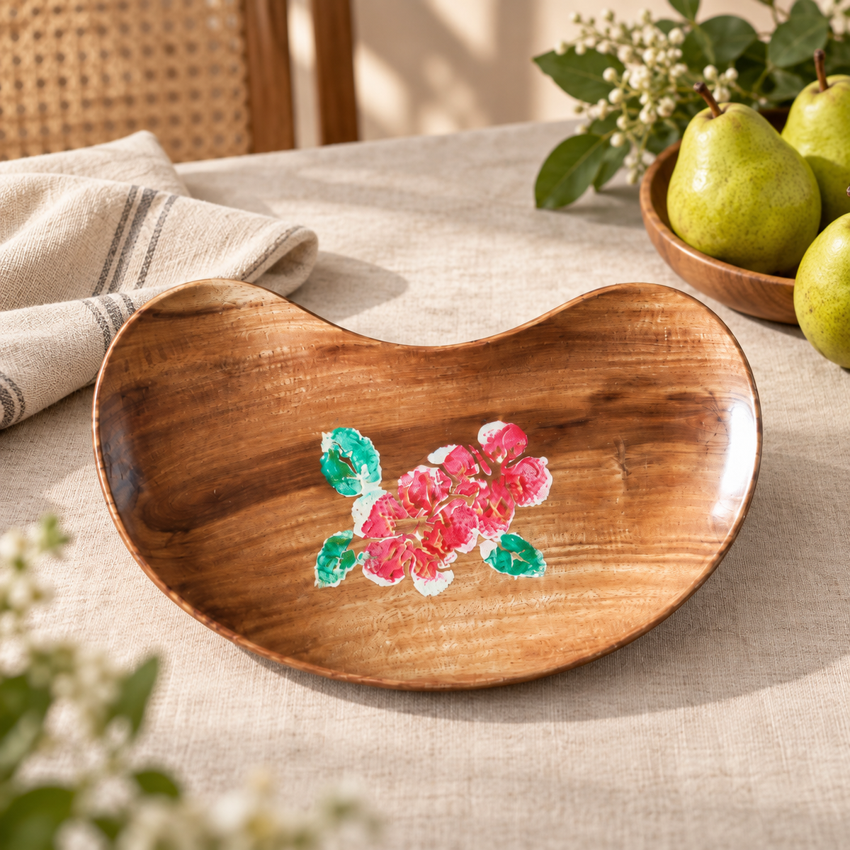 Brown wooden tray with pink floral detail styled with fruit and linen. hoWme