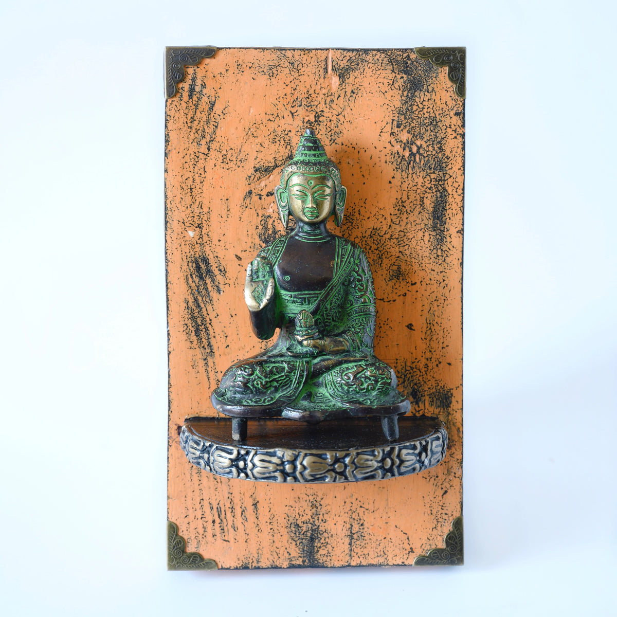 Brass Buddha artefact mounted on a handcrafted wooden block for wall décor – hoWme