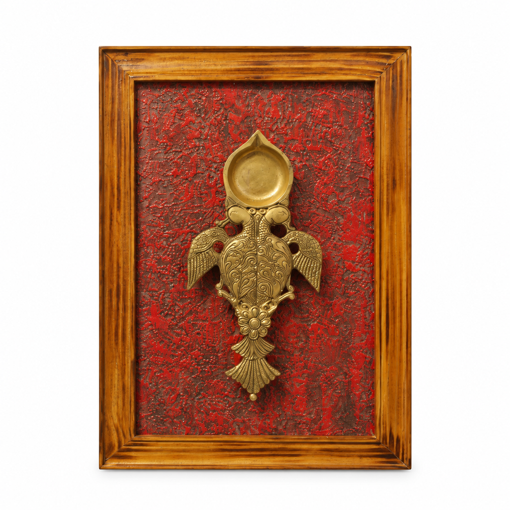 Handcrafted framed brass aarti diya on maroon backdrop – front view for wall décor – hoWme