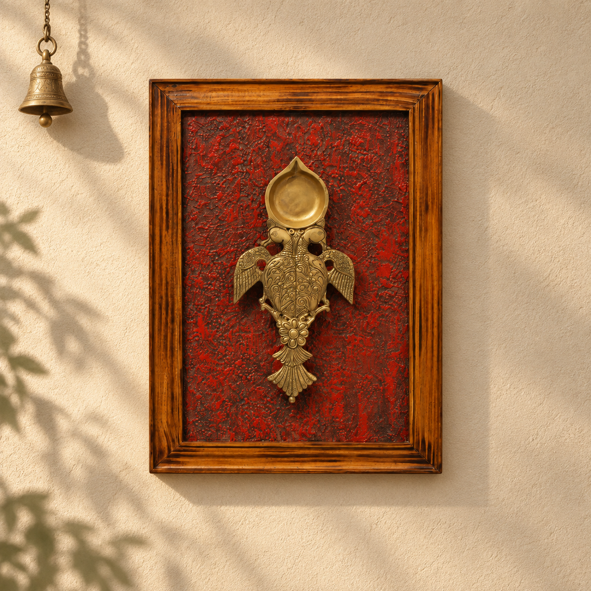 Handcrafted framed brass aarti diya on maroon backdrop – wall styling – hoWme