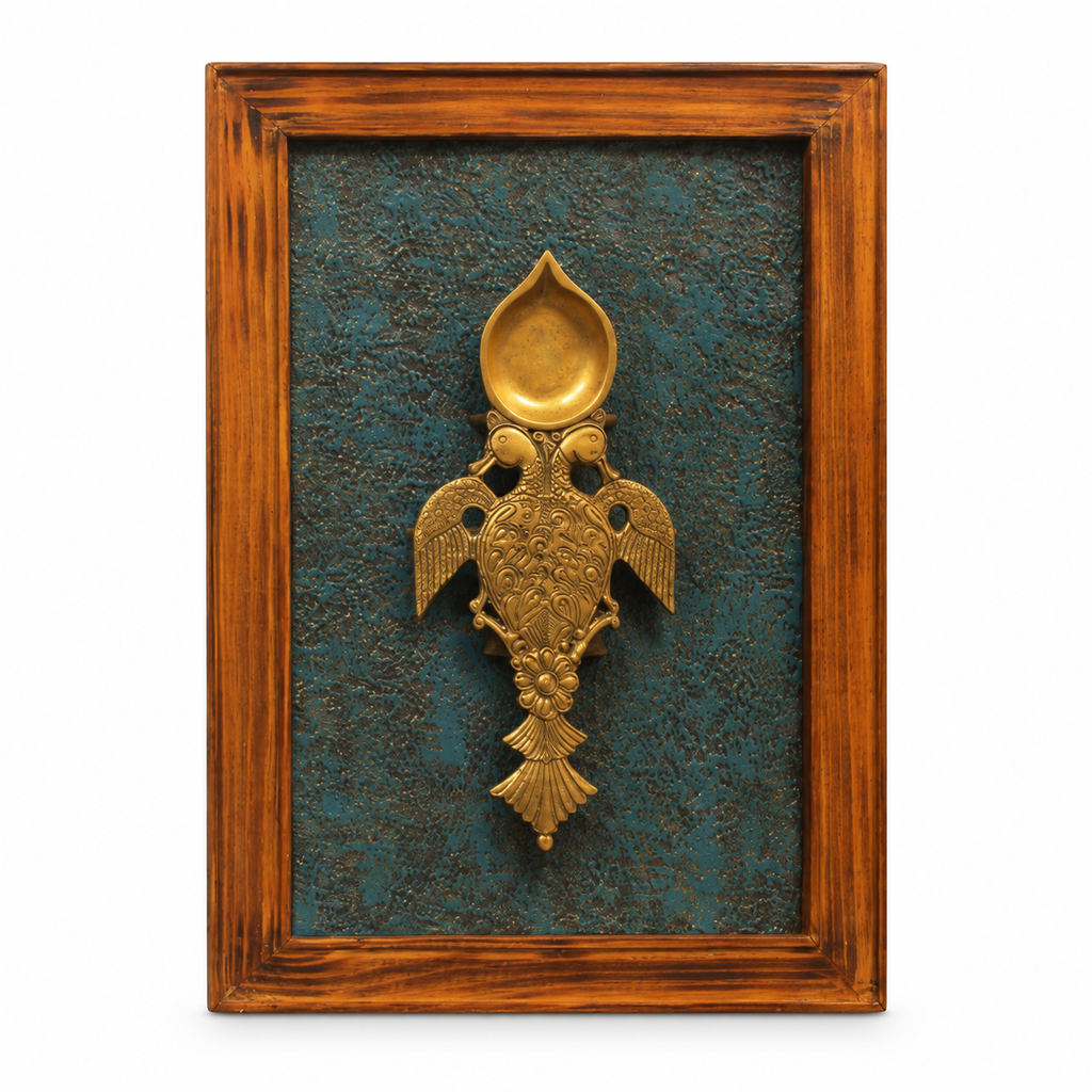 Handcrafted framed brass aarti diya on teal backdrop – front view for wall décor – hoWme