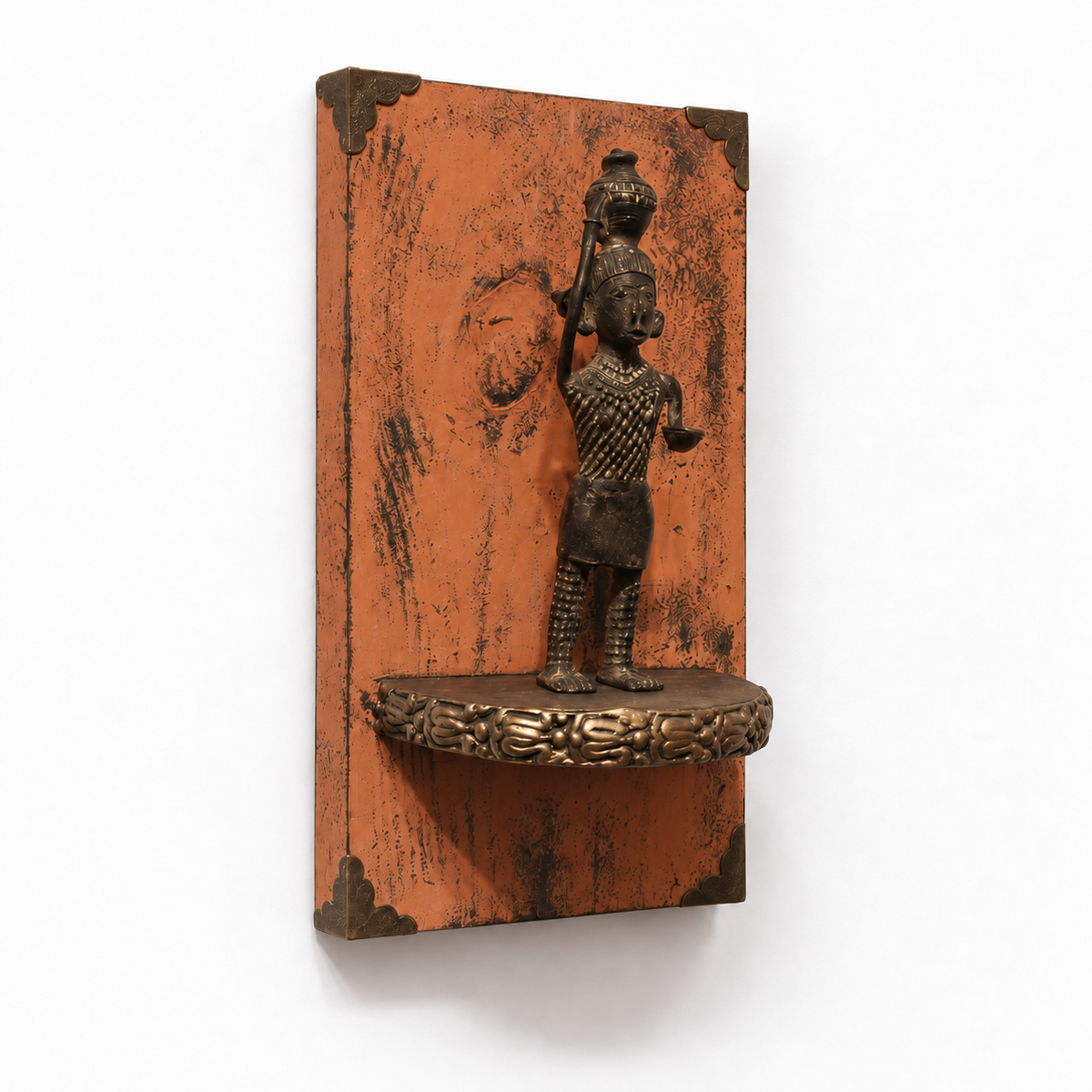 Angled view of orange wooden wall shelf with brass figurine – hoWme