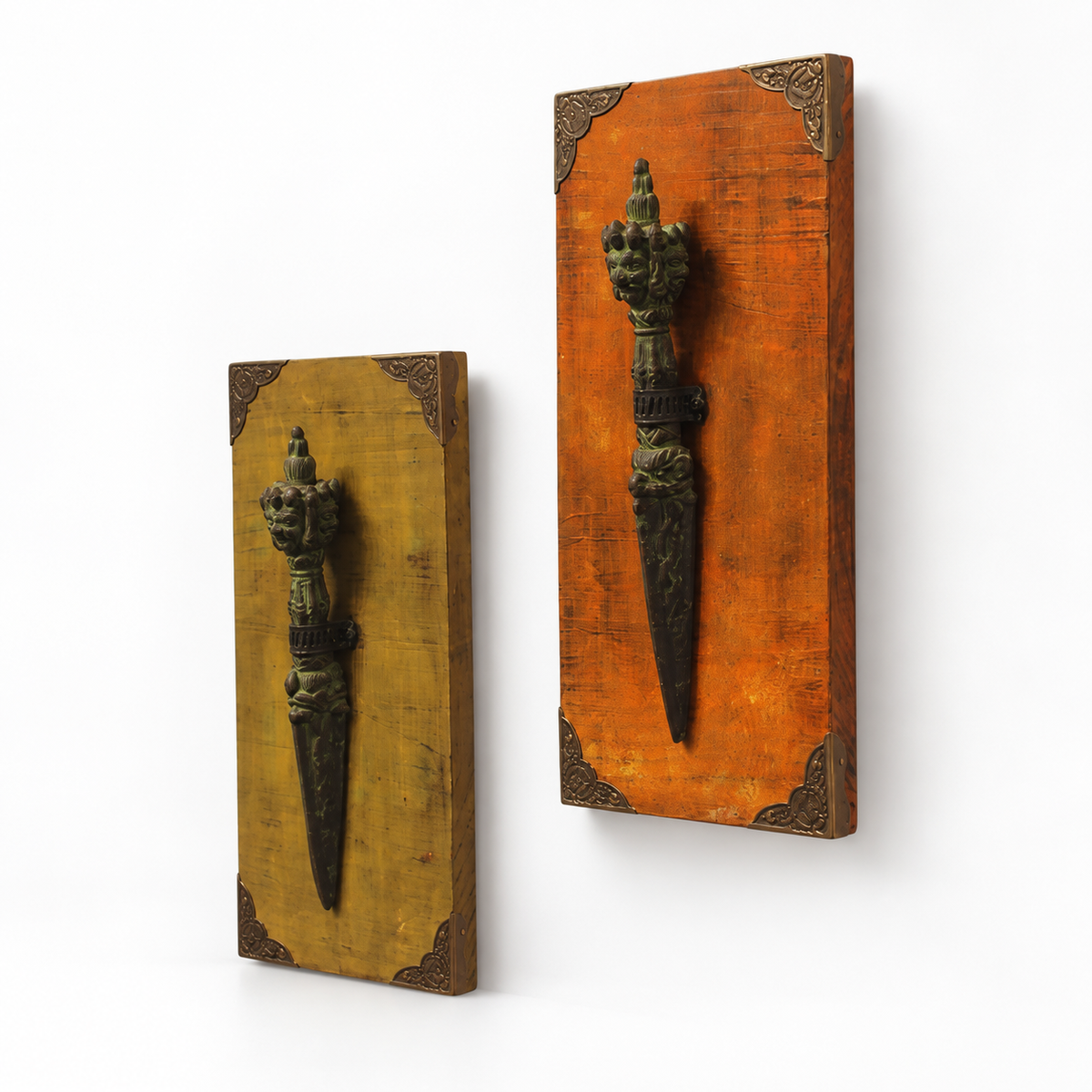Pair of orange and yellow wooden wall panels with raised metal artefacts. hoWme
