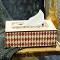 Red geometric mosaic decoupage MDF tissue holder with brass feet on a wooden table – hoWme