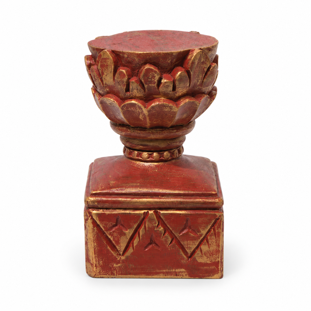 Red and gold carved wooden pedestal, detail view on a white background. hoWme