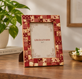Red patchwork wooden photo frame styled on a table with plant and decor hoWme