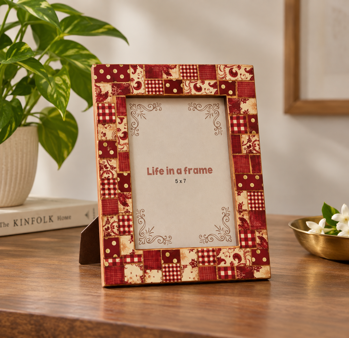 Red patchwork wooden photo frame styled on a table with plant and decor hoWme
