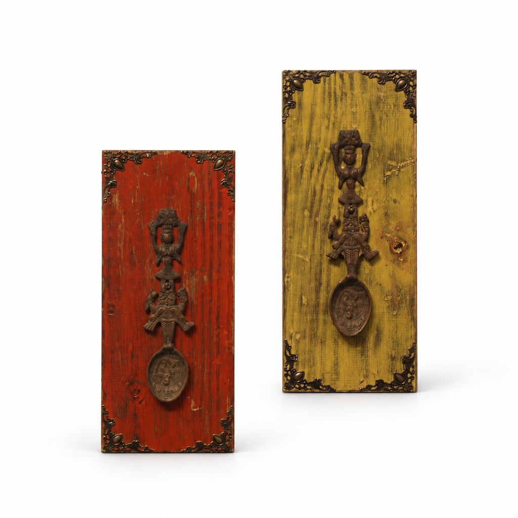 Pair of red and yellow wooden wall panels with raised brass artefacts. hoWme
